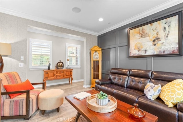 living area with light wood-type flooring, crown molding, a decorative wall, and baseboards