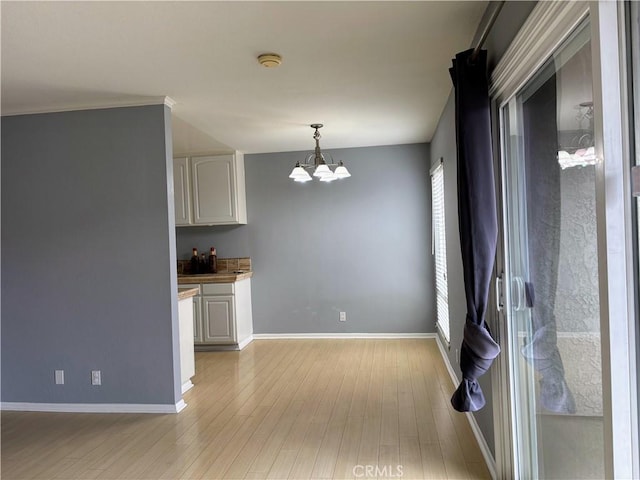 interior space with a chandelier and light hardwood / wood-style flooring