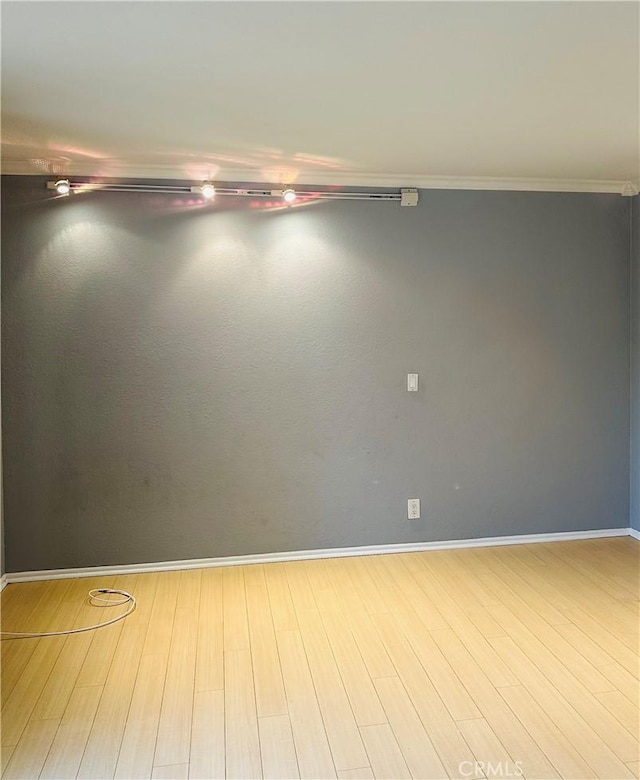 unfurnished room with ornamental molding and light hardwood / wood-style floors