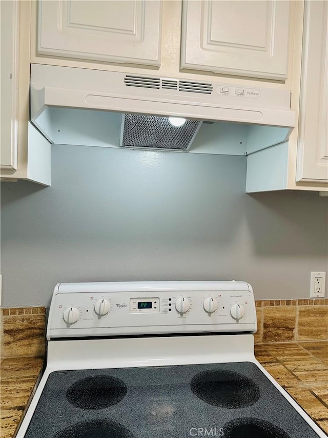 room details with white electric range oven and white cabinets