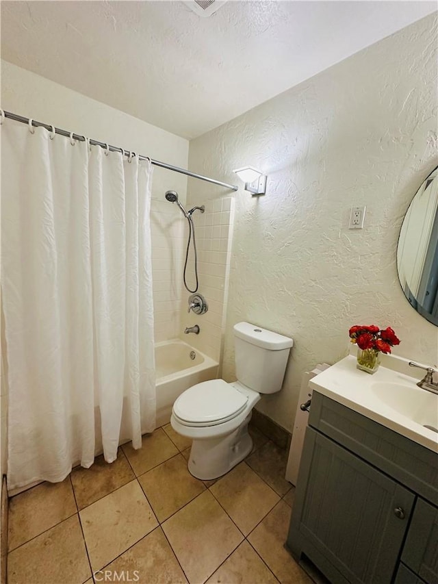 full bathroom with vanity, a textured ceiling, tile patterned floors, toilet, and shower / bath combo with shower curtain