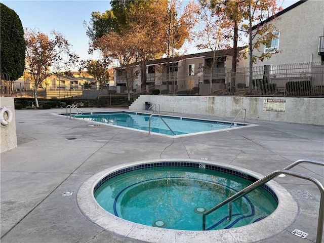 view of swimming pool with a community hot tub and a patio