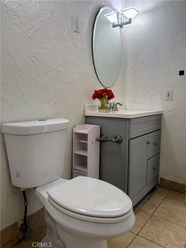 bathroom featuring vanity, toilet, and tile patterned flooring