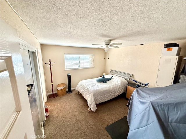 carpeted bedroom with a textured ceiling and ceiling fan