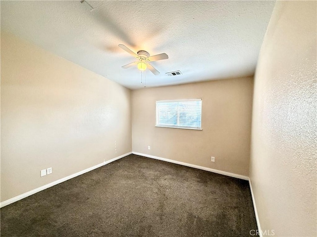 carpeted spare room with ceiling fan and a textured ceiling