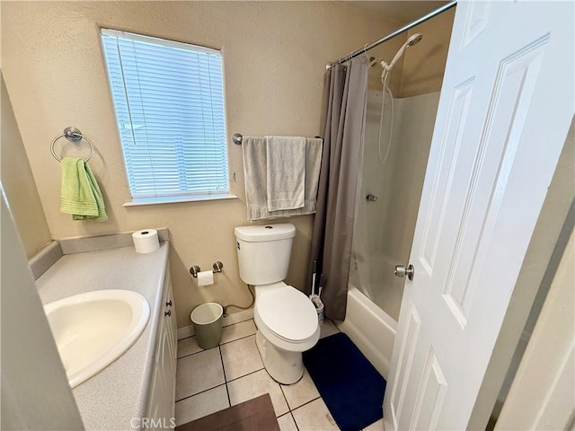 full bathroom featuring tile patterned flooring, vanity, toilet, and shower / bathtub combination with curtain