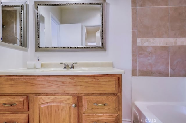 bathroom featuring vanity and a washtub