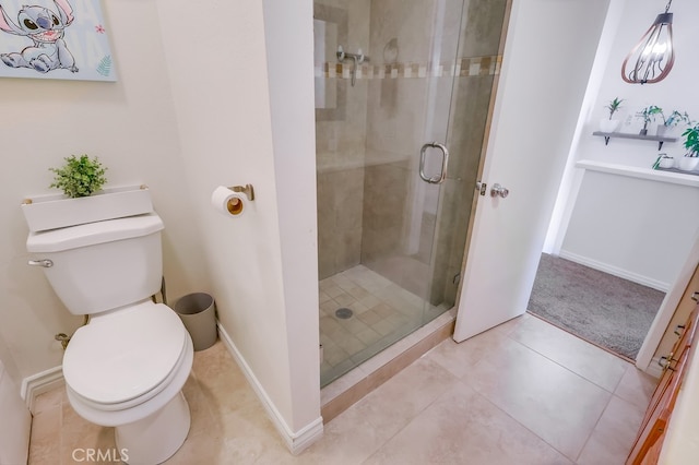 bathroom featuring tile patterned flooring, toilet, and walk in shower