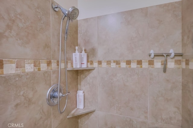 interior details featuring a tile shower