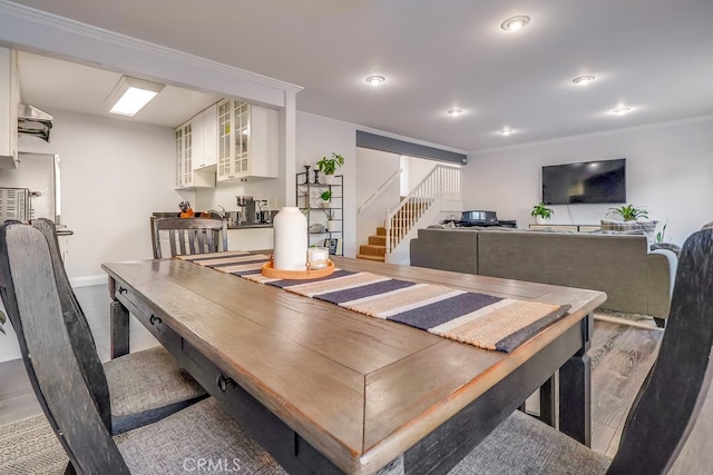 dining room with crown molding and hardwood / wood-style flooring