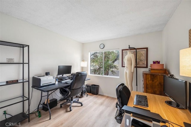 office with a textured ceiling and light hardwood / wood-style flooring