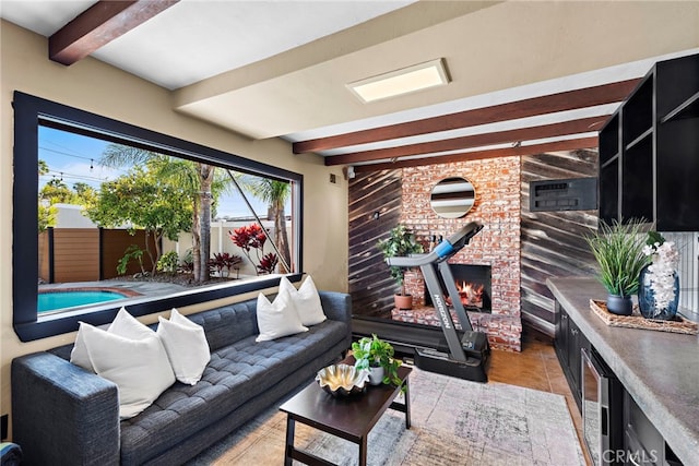 interior space featuring a brick fireplace and beam ceiling