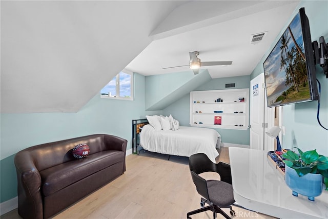 bedroom with ceiling fan, vaulted ceiling, and light wood-type flooring