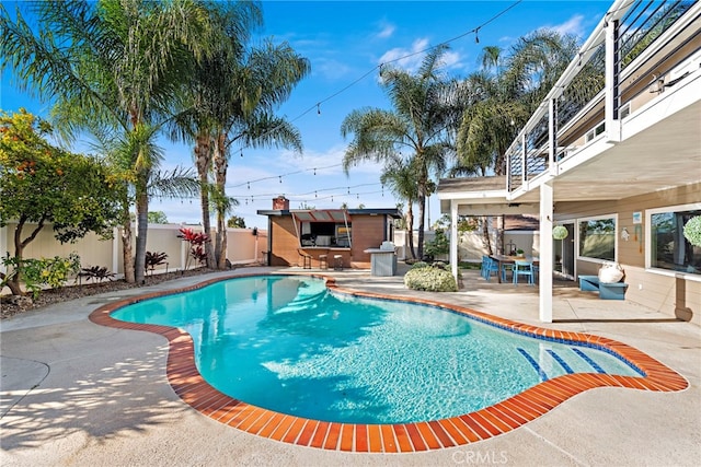 view of swimming pool with a bar and a patio area