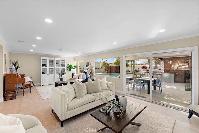 living room featuring crown molding and light hardwood / wood-style floors