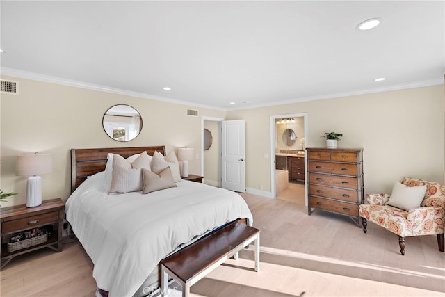 bedroom featuring ornamental molding, connected bathroom, and light hardwood / wood-style flooring