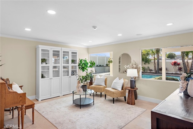 living room with crown molding and light wood-type flooring