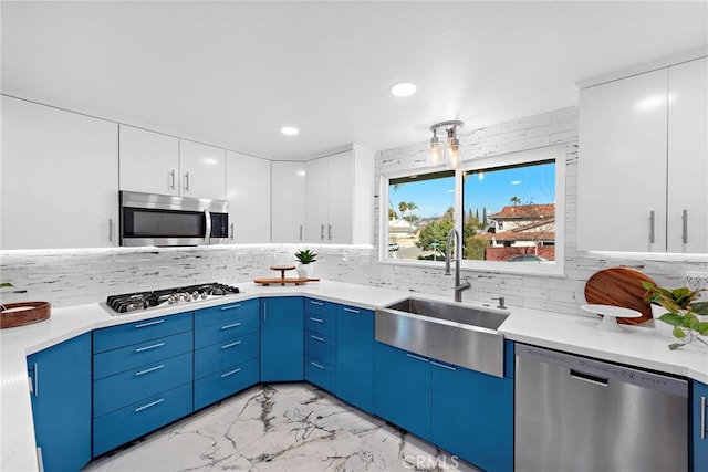 kitchen featuring white cabinetry, sink, decorative backsplash, and appliances with stainless steel finishes