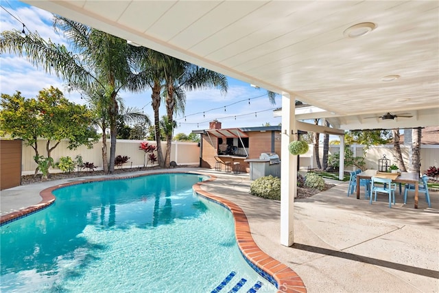 view of pool featuring exterior bar and a patio area