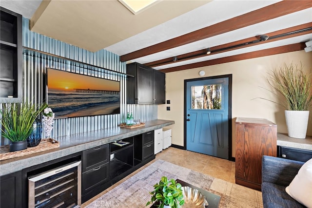 kitchen with beamed ceiling, light tile patterned floors, and beverage cooler