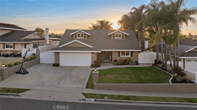 view of front of property featuring a garage and a yard