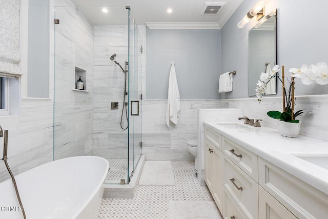 full bathroom with tile patterned floors, ornamental molding, tile walls, independent shower and bath, and vanity