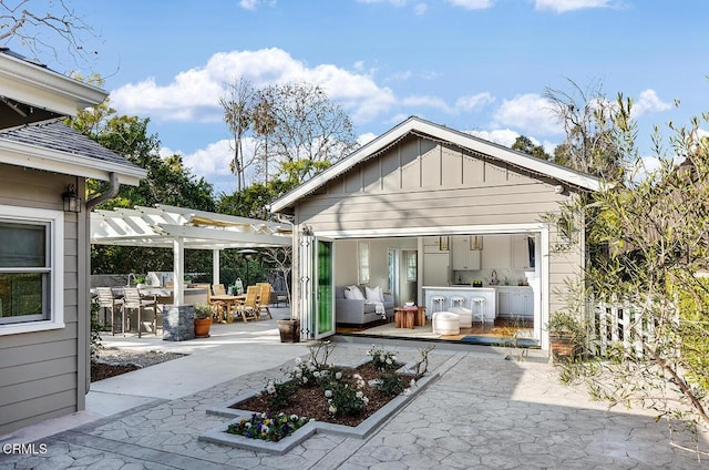 back of property with a patio area, a pergola, and sink