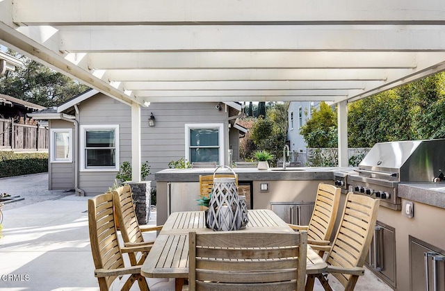 view of patio / terrace with sink, grilling area, a pergola, and exterior kitchen