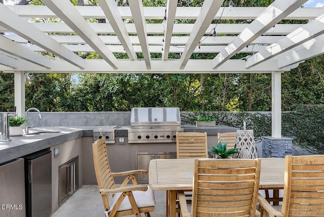 view of patio with an outdoor kitchen, sink, a pergola, and grilling area