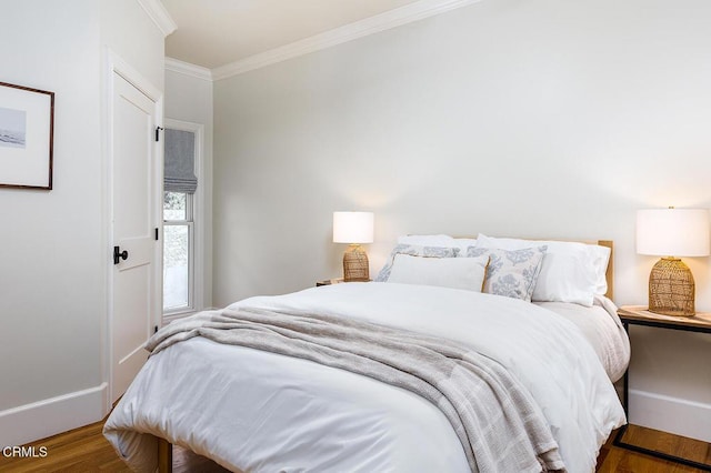 bedroom with dark hardwood / wood-style flooring and ornamental molding