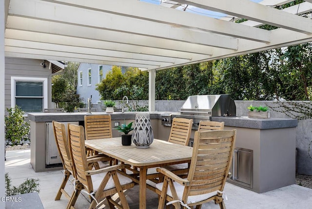 view of patio / terrace with a pergola, area for grilling, exterior kitchen, and an outdoor bar