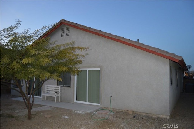 rear view of property featuring a patio area