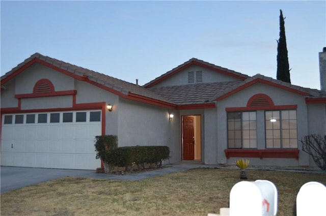 view of front of house with a garage and a front lawn