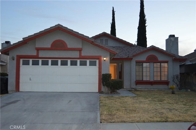 view of front facade featuring a garage and a front lawn