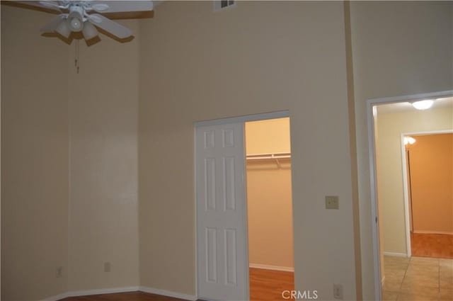 unfurnished bedroom featuring a walk in closet and a closet