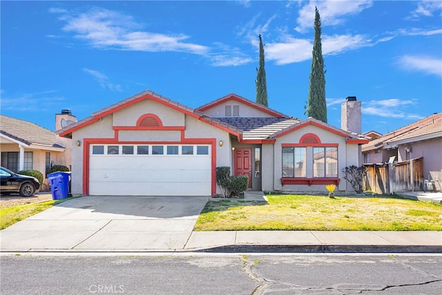 view of front of house featuring a garage, concrete driveway, a tile roof, a front yard, and stucco siding