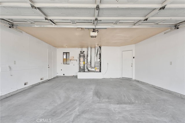 garage featuring a garage door opener and strapped water heater