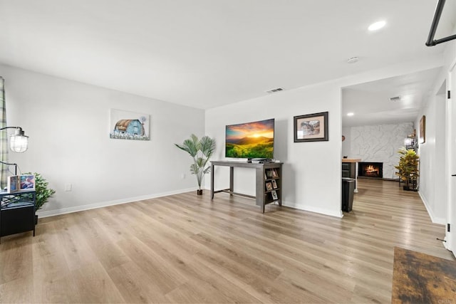 26639 Chambers Ave, Menifee, CA 92586 - living room with visible vents, light wood-style floors, baseboards, recessed lighting, and a premium fireplace