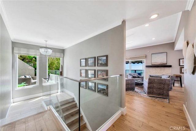 920 Quivera St, Laguna Beach, CA 92651 - stairway featuring plenty of natural light, hardwood / wood-style flooring, a chandelier, ornamental molding, and recessed lighting