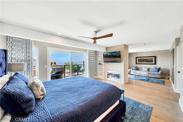 920 Quivera St, Laguna Beach, CA 92651 - bedroom with access to exterior, wood finished floors, a fireplace, ceiling fan, and recessed lighting
