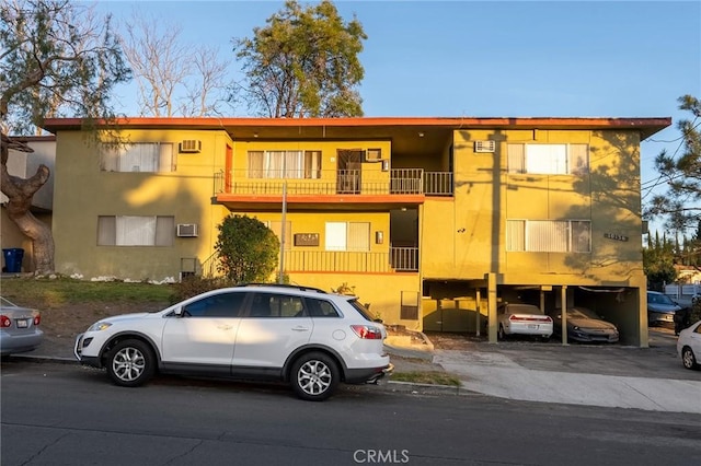 view of building exterior featuring a wall unit AC