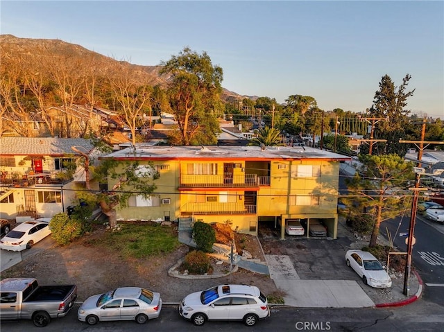 view of front of home featuring a balcony and a mountain view