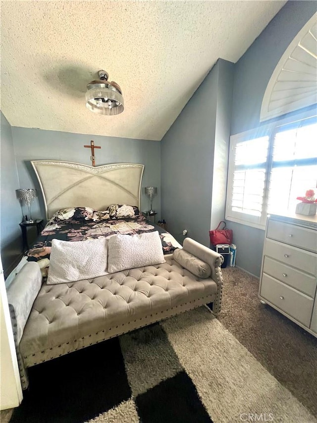 bedroom featuring vaulted ceiling, carpet, and a textured ceiling