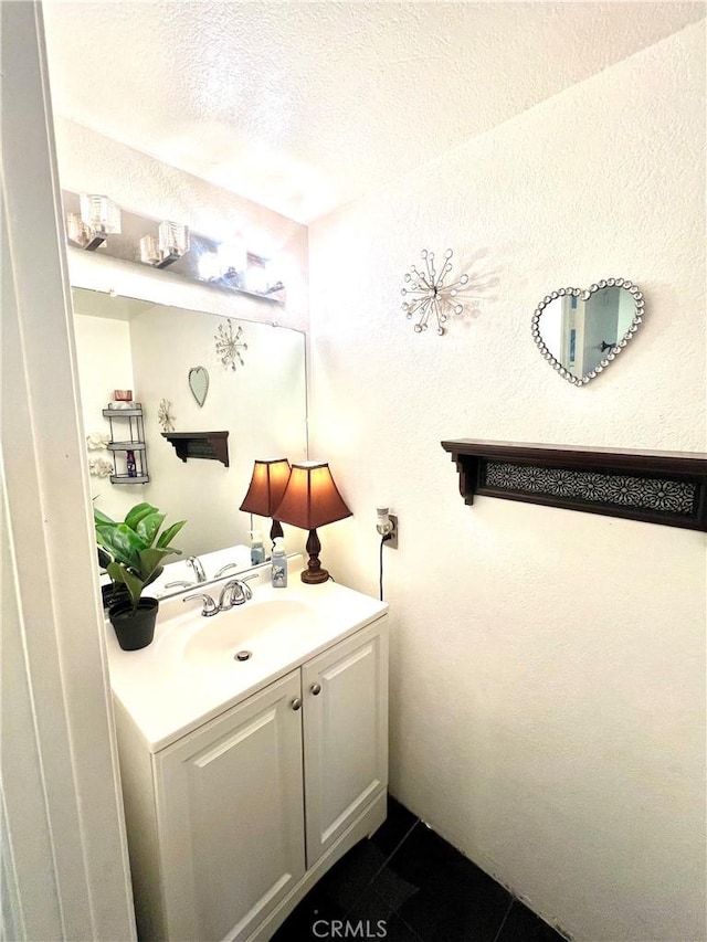 bathroom featuring vanity and a textured ceiling