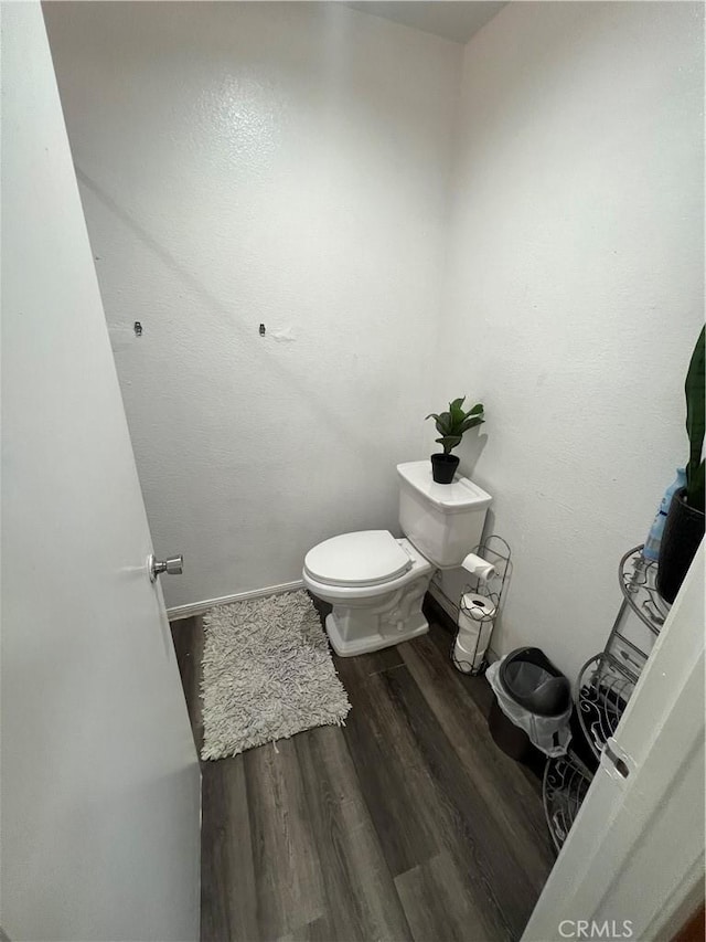 bathroom with toilet and hardwood / wood-style floors