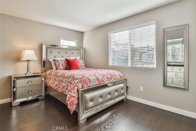 bedroom with dark hardwood / wood-style flooring