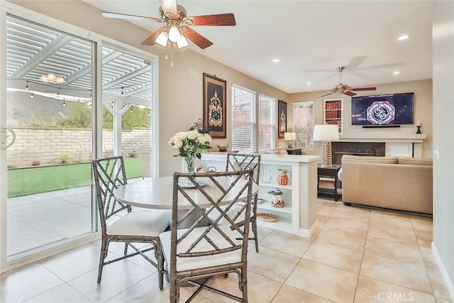 tiled dining space featuring ceiling fan