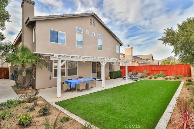 back of property with a lawn, a pergola, and a patio area