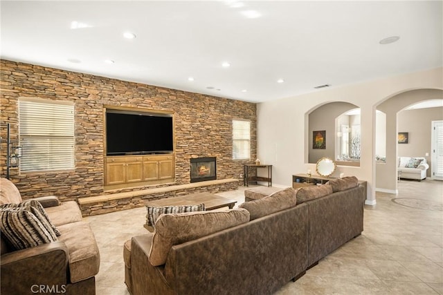 tiled living room featuring a fireplace