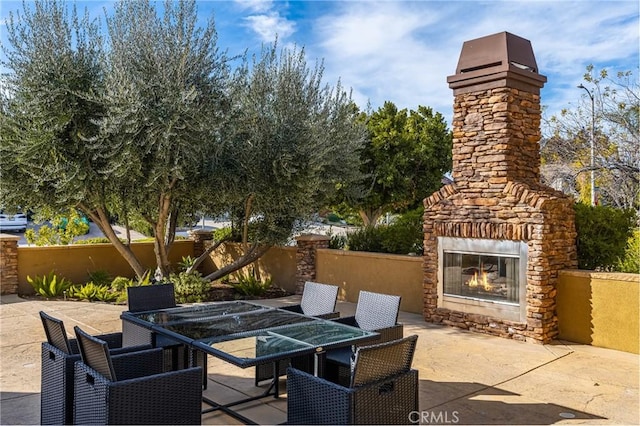 view of patio / terrace featuring an outdoor stone fireplace